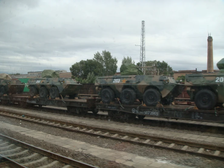 a bunch of tanks that are on a train track