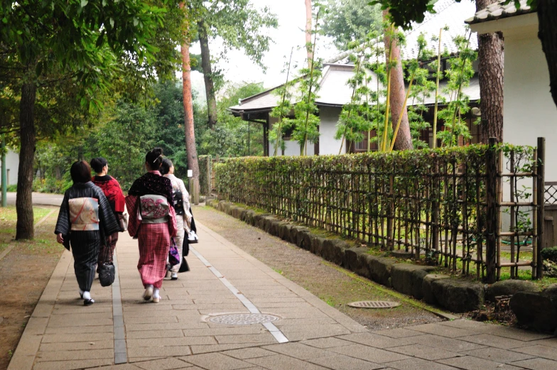 some pretty ladies walk down the road together