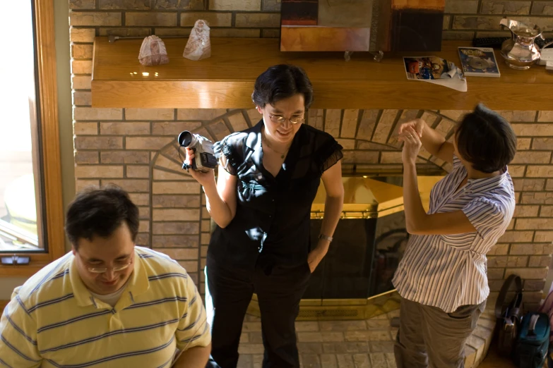 two women and two men are taking pictures