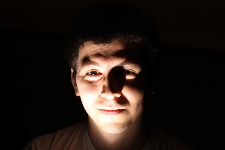 a man standing in the dark with his shadow projected on him