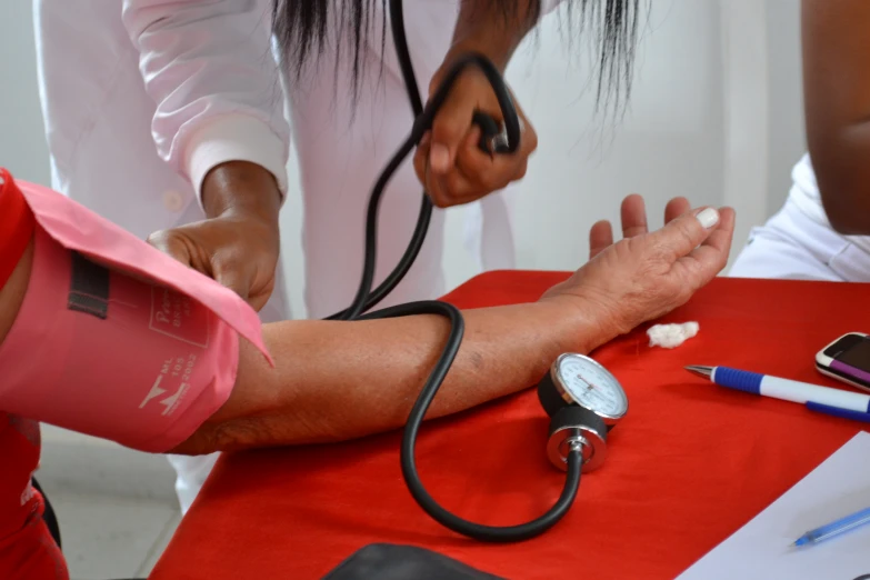 a person laying down with a  pressure gauge on their arm