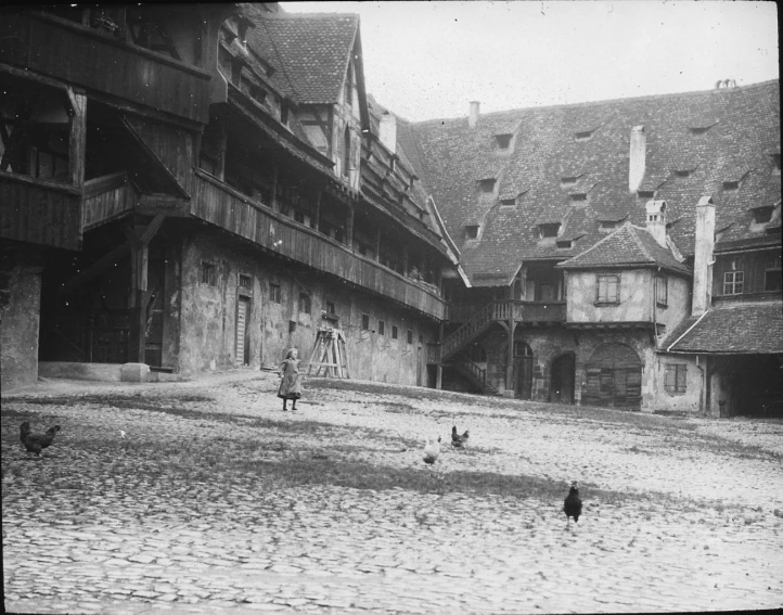 a city street that has old buildings and people walking down it