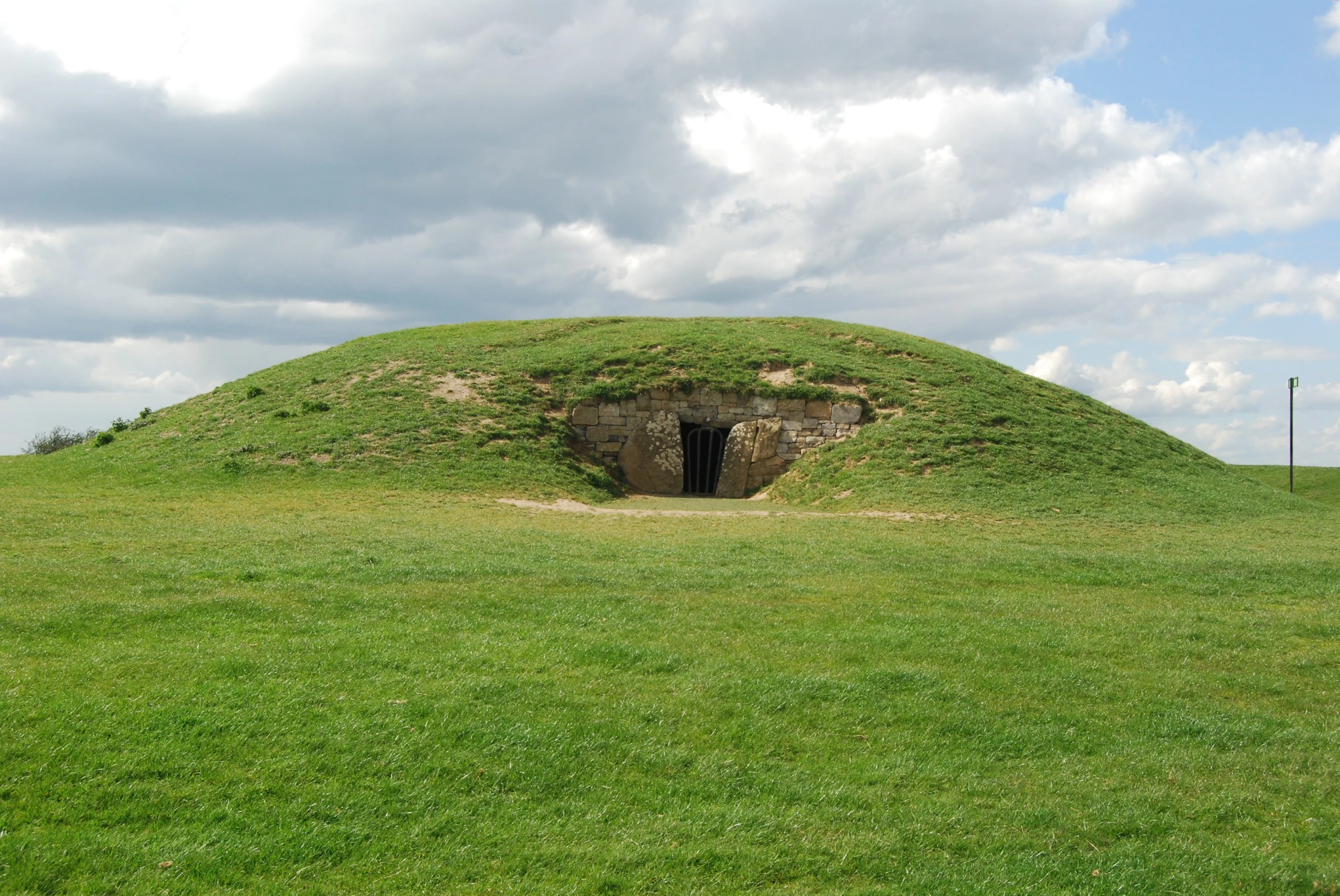 an open air bunker in a field on a cloudy day