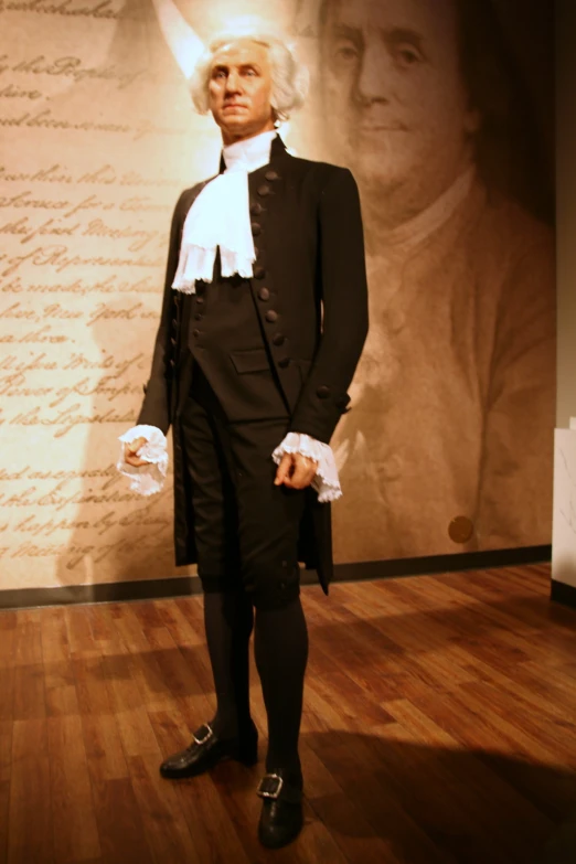 a man in a black suit and white top hat