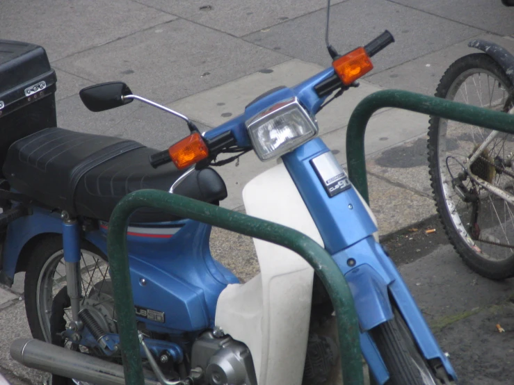 a motor scooter parked by a curb