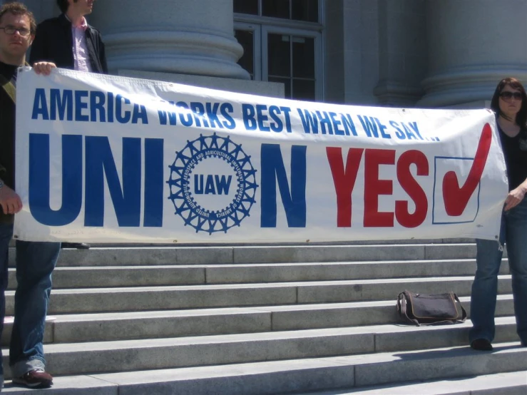 some people hold up a banner for union yes