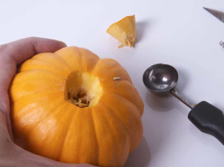 an orange that has been cut off and is being held