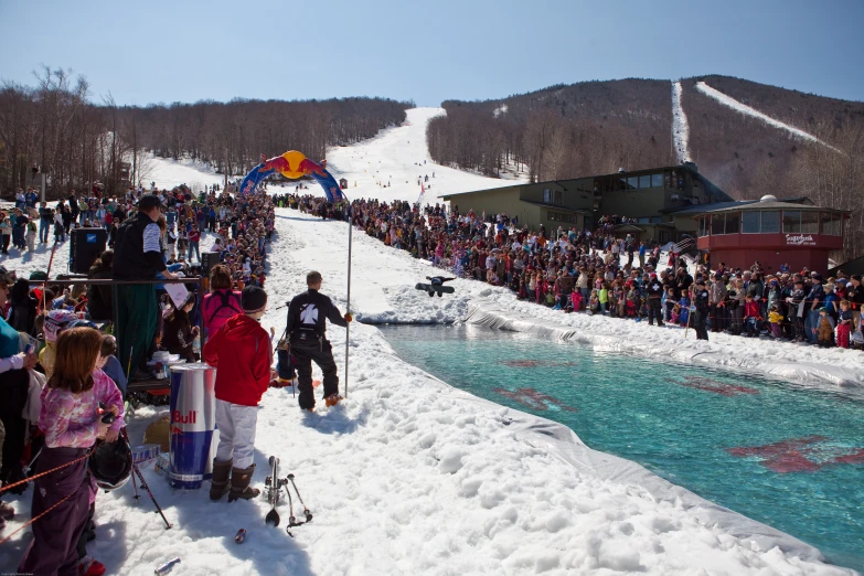 a group of people standing on top of a snow covered slope