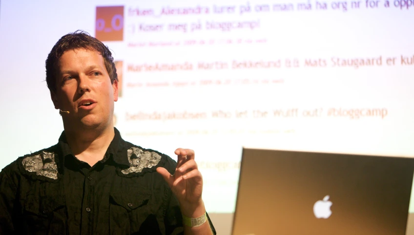 a person holding a laptop while giving a presentation