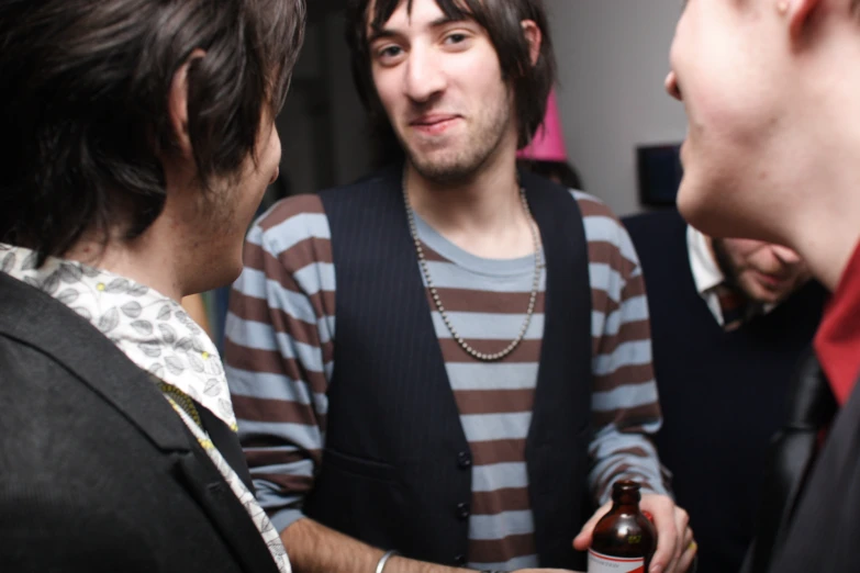 a group of men standing around each other talking