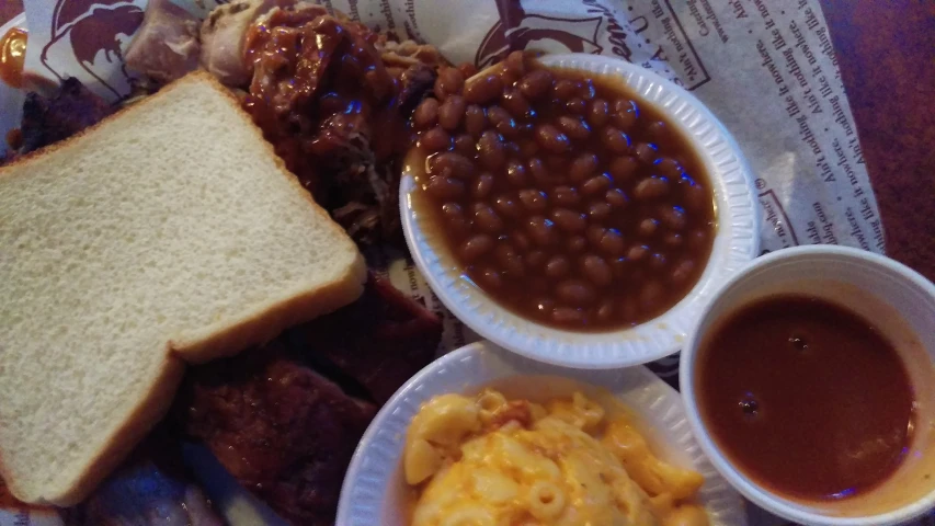 sandwiches, beans, and sides are on the table