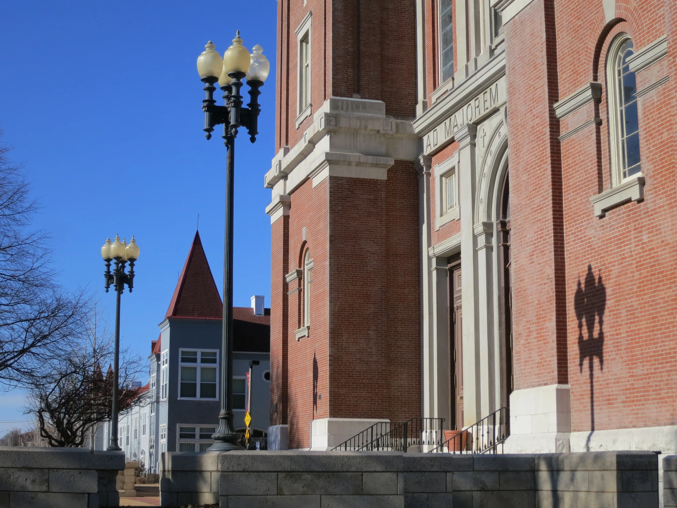 the lamp post is next to a brick building