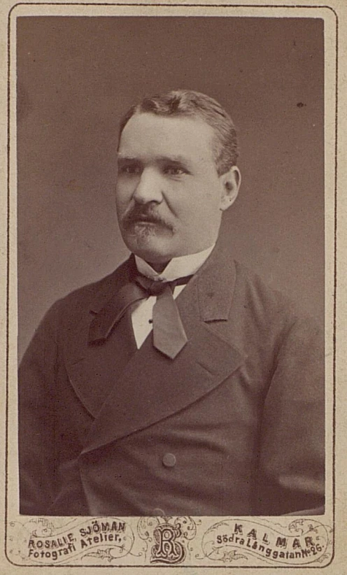 a vintage portrait of a man in a jacket and tie