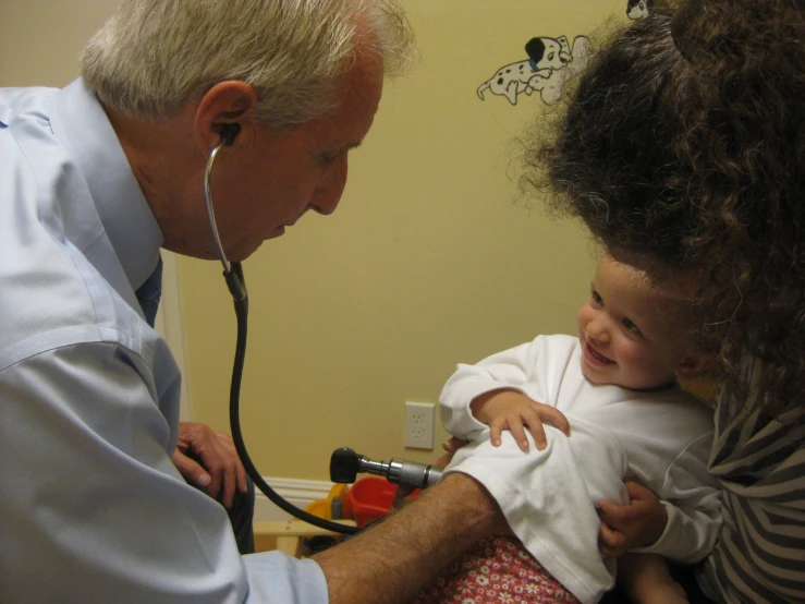 a young child being checked by a doctor