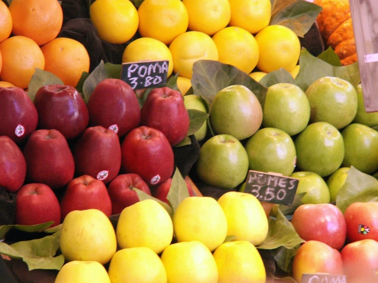 a table top display of apples, oranges and apples