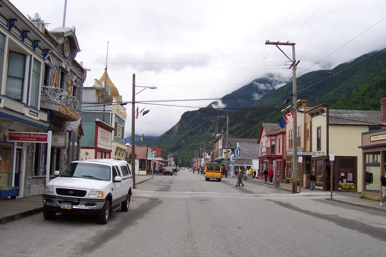 the car is driving through an old town