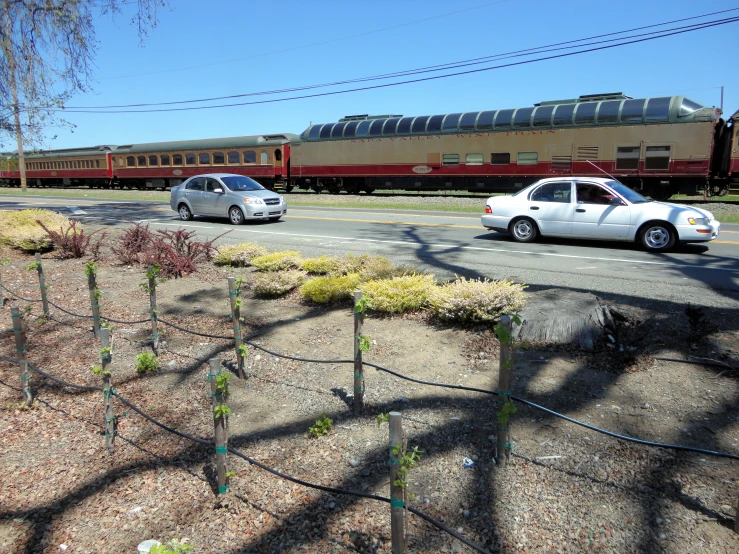 a couple of cars traveling down train tracks