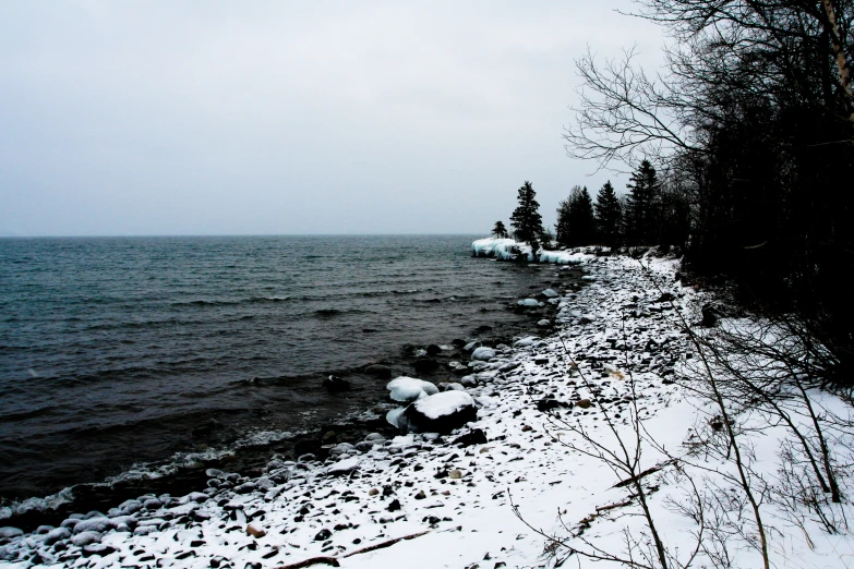 the shoreline is covered in snow and ice