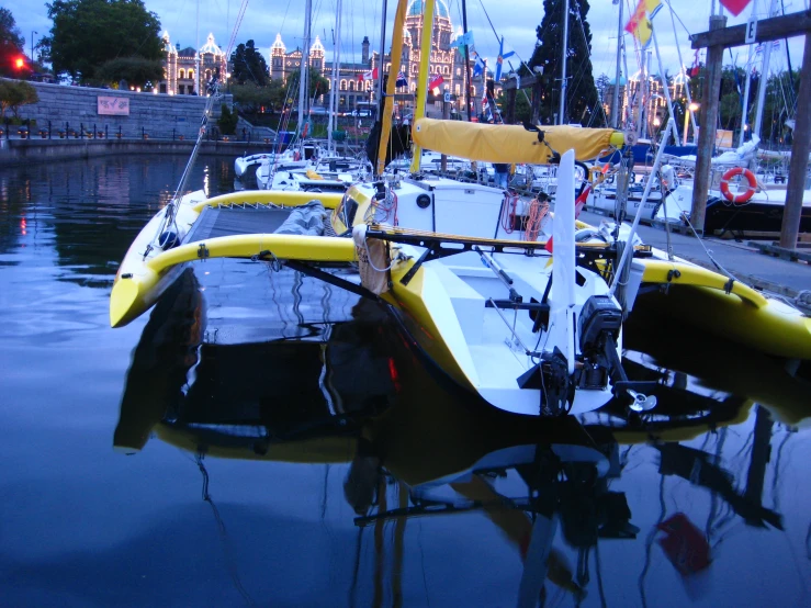 a couple of sailboats sitting at a dock in the water