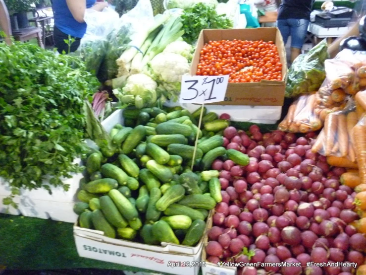 produce sitting on display in boxes for sale at a market