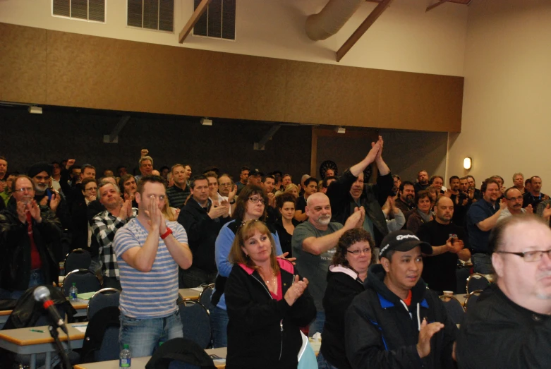 a group of people standing and sitting in front of a crowd