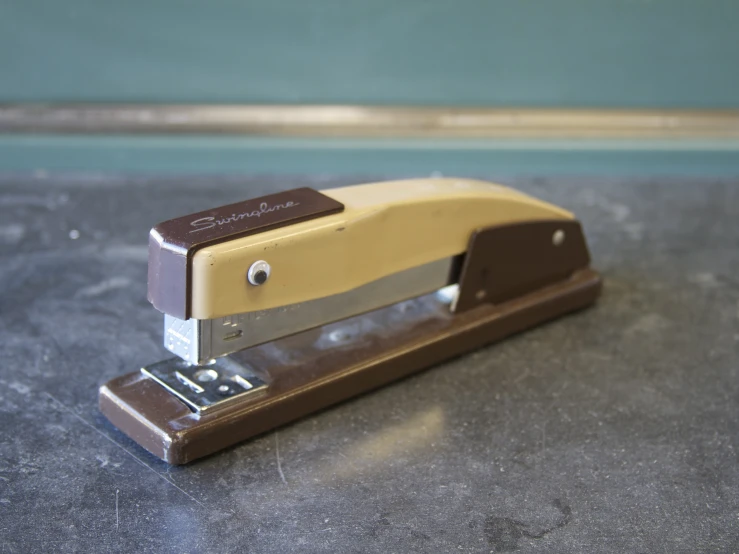 a stapler with a piece of wood on it
