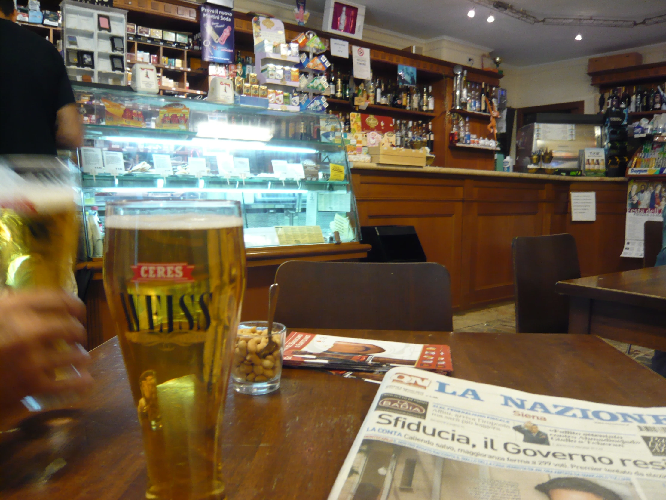 the bar has beers and magazines on the table