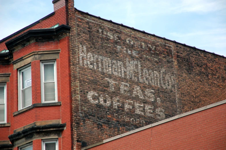 a brick building with old painted on it