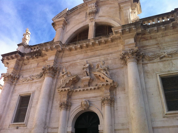 a tall, intricate cathedral sits on the side of a large building