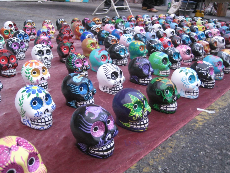 a row of skulls of different colors on display