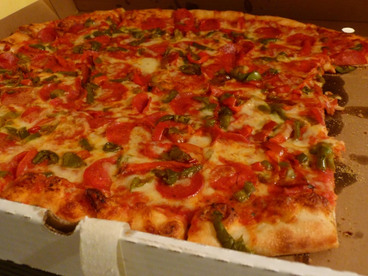 a large pizza with several different toppings sitting in a box