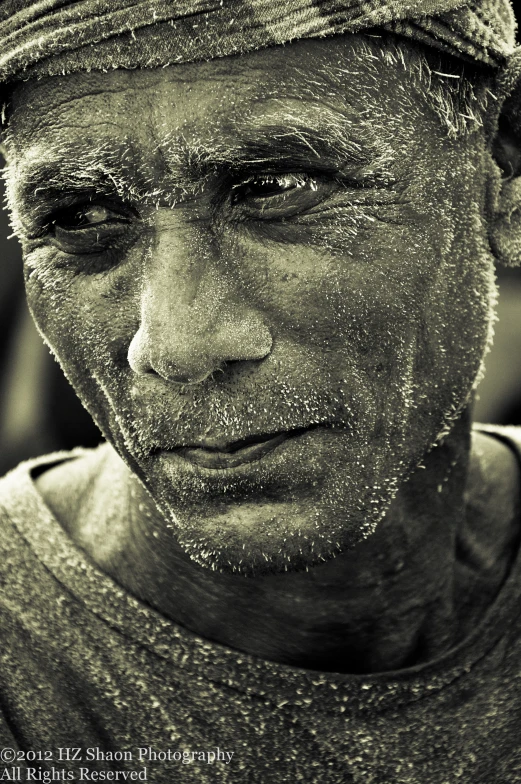 a black and white po of an old man looking directly at the camera