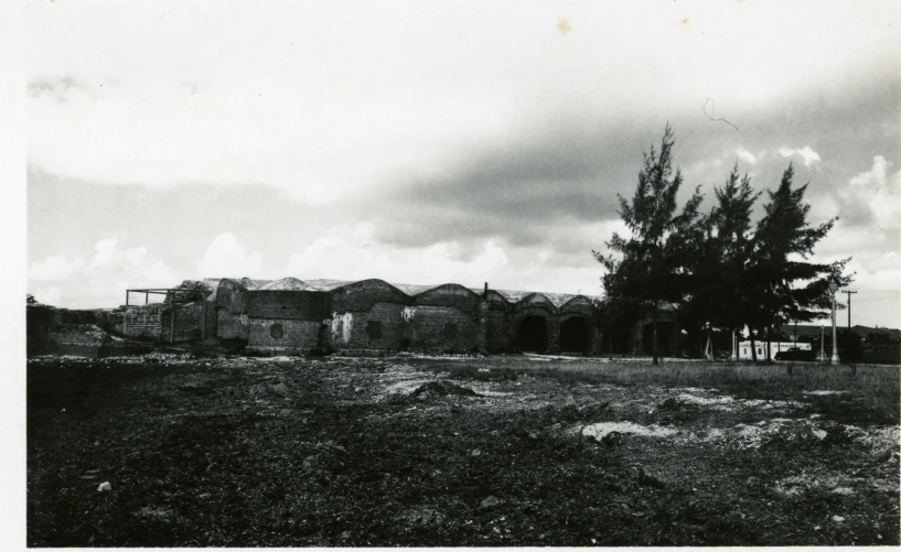 an old picture of a large building with trees