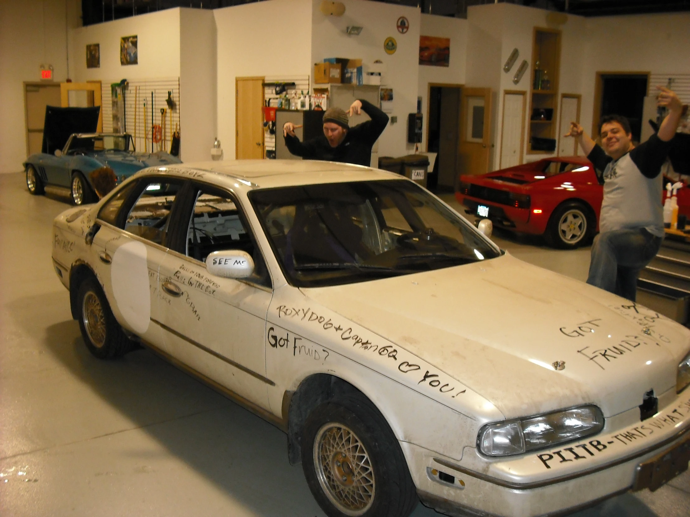 the cars are parked in the garage in front of people