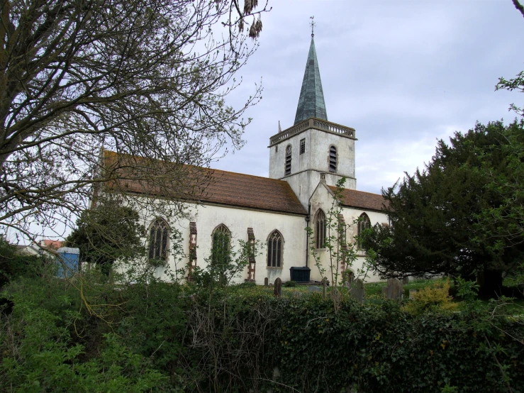 an old church sits amid lush greenery in the daytime