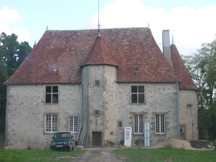 an old building with stone walls and shingles