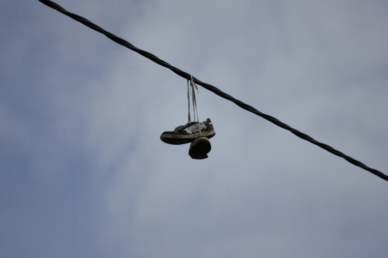 an old sneaker on top of a power line