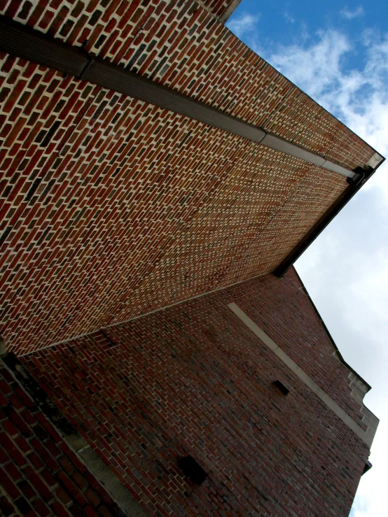 an angle view looking up at a building made out of brick