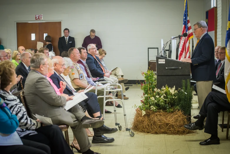 a bunch of people sitting in chairs watching an event