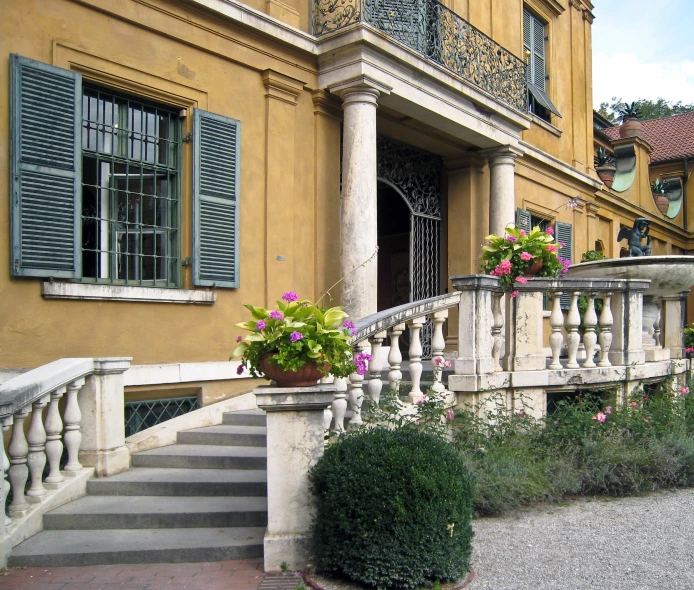 a balcony with steps, planters and flower pots