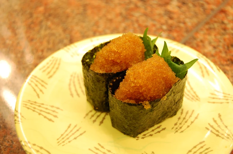 two sushi rolls are sitting on a plate