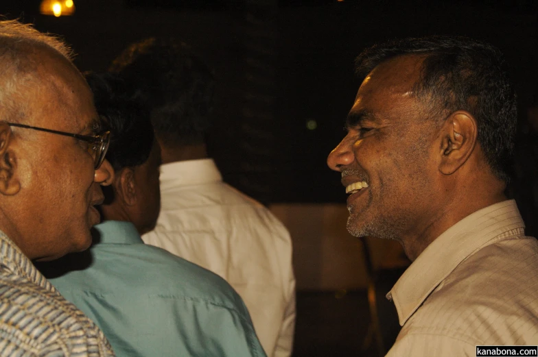 two men are talking together at an event