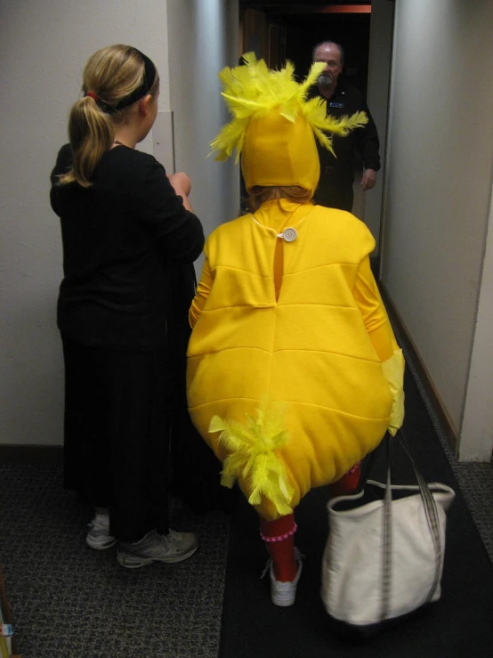 a woman in a costume is standing in the corridor