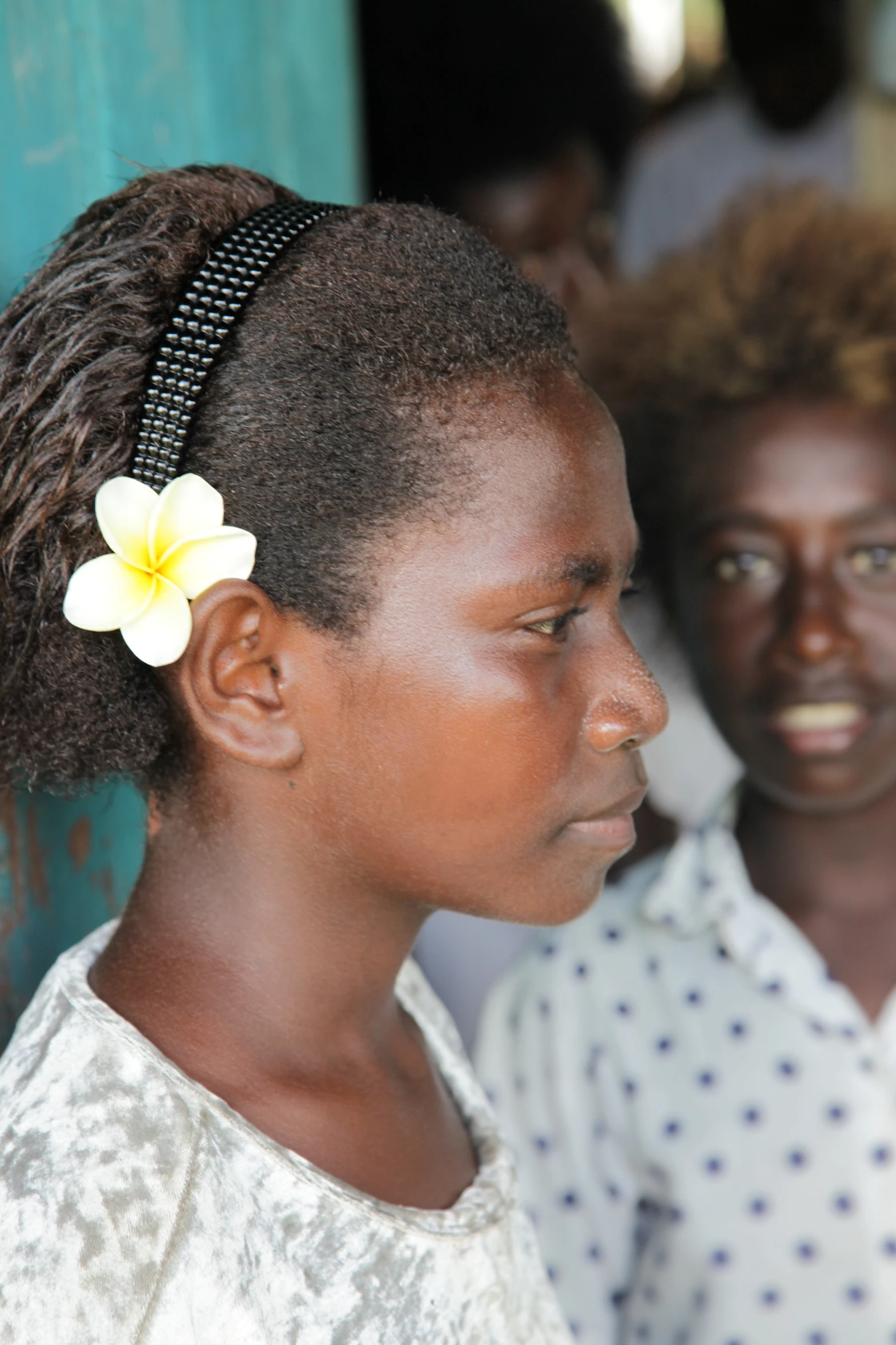 a young woman with a flower in her hair