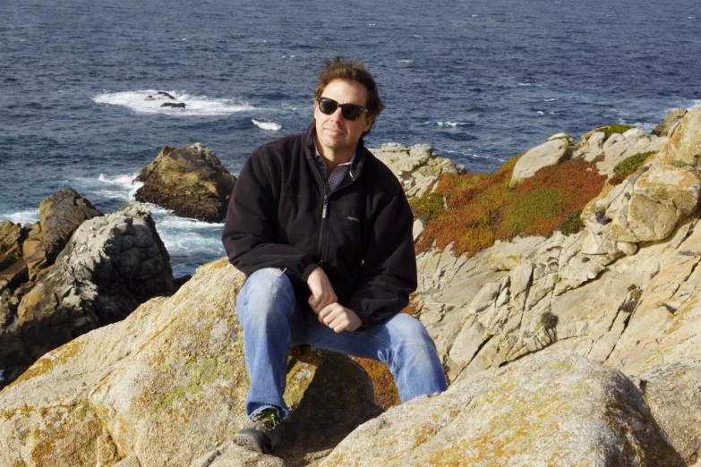 a person sitting on top of some large rocks