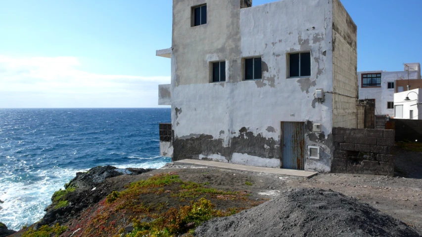 a house on a cliff overlooking the ocean