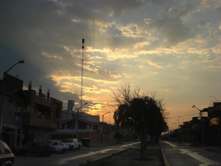 the sun is setting on an empty street