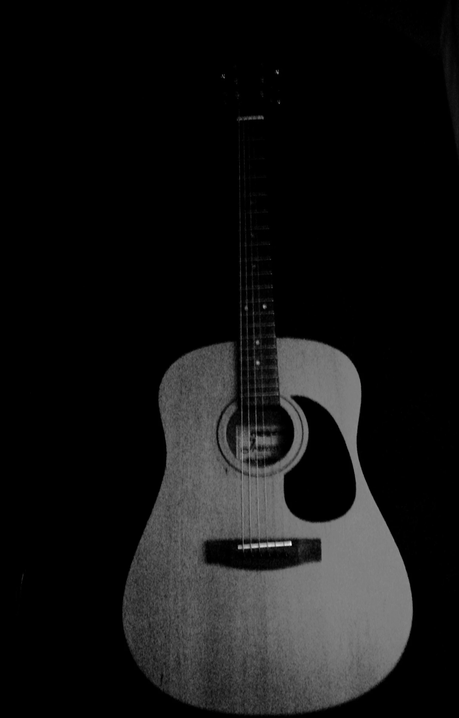 a black and white po of an acoustic guitar