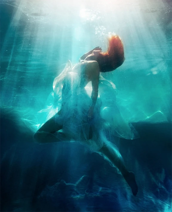 a woman in an open water po that has sunlight shining through the water