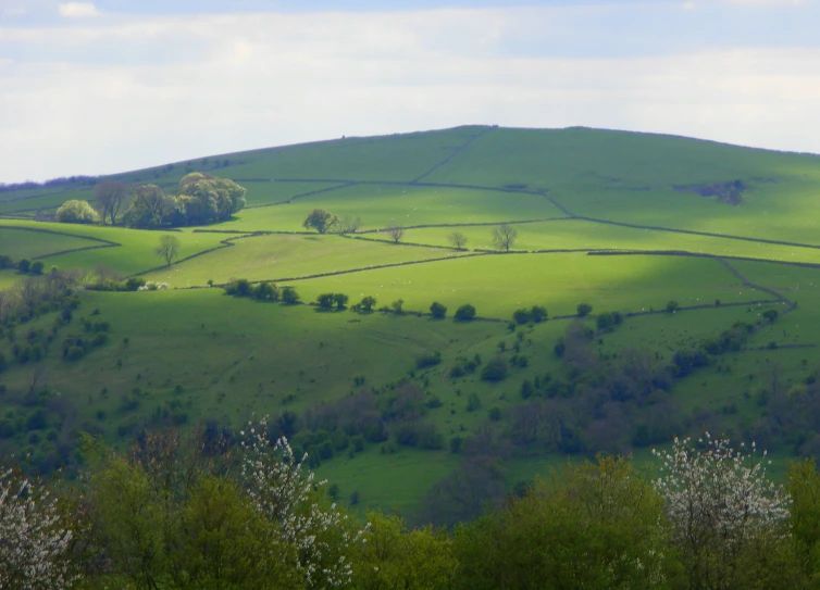 an aerial view of a green hilly country side